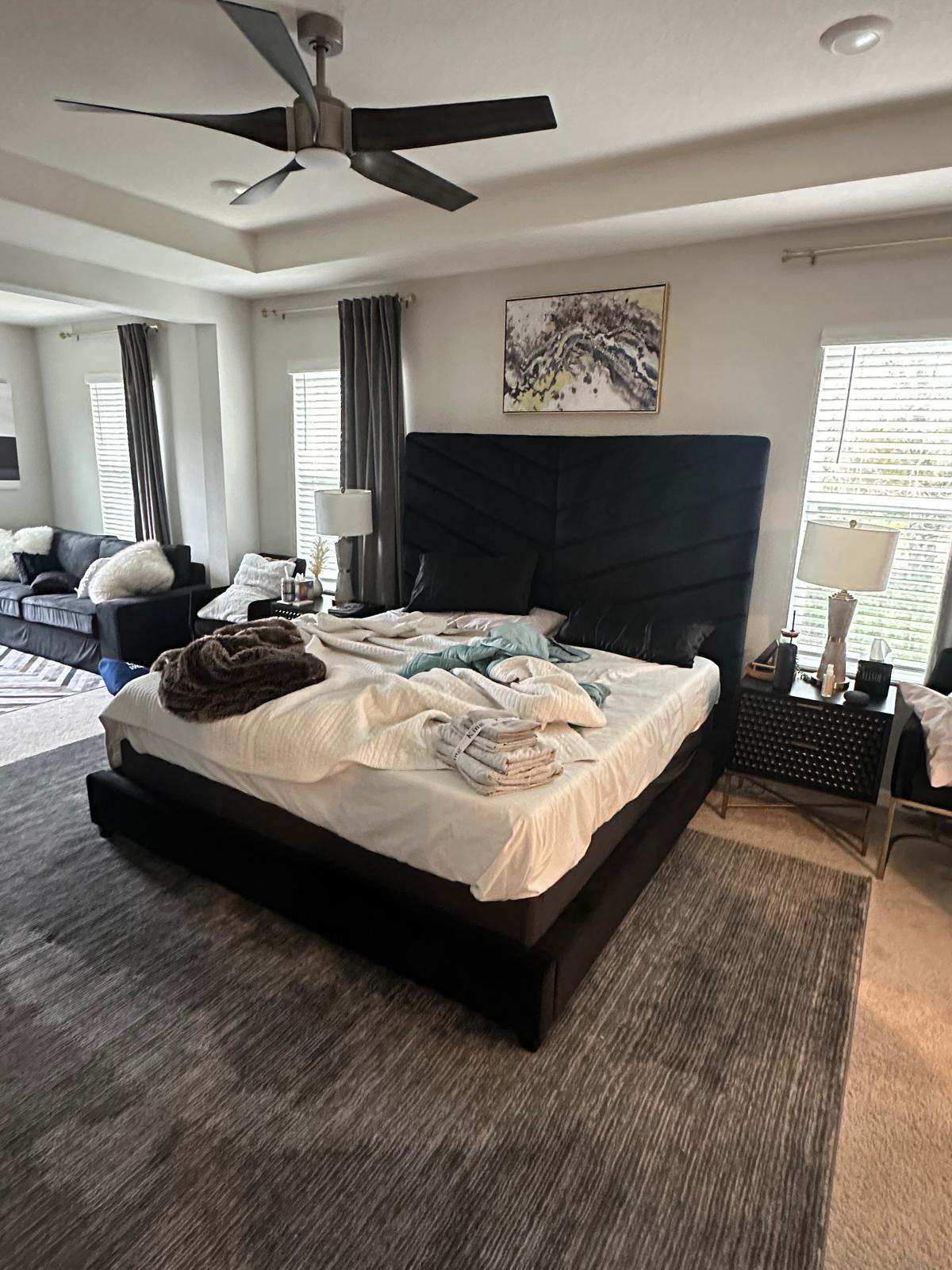 Unmade bed and cluttered bedroom before professional cleaning by Vicillas Cleaning Solutions St Petersburg FL