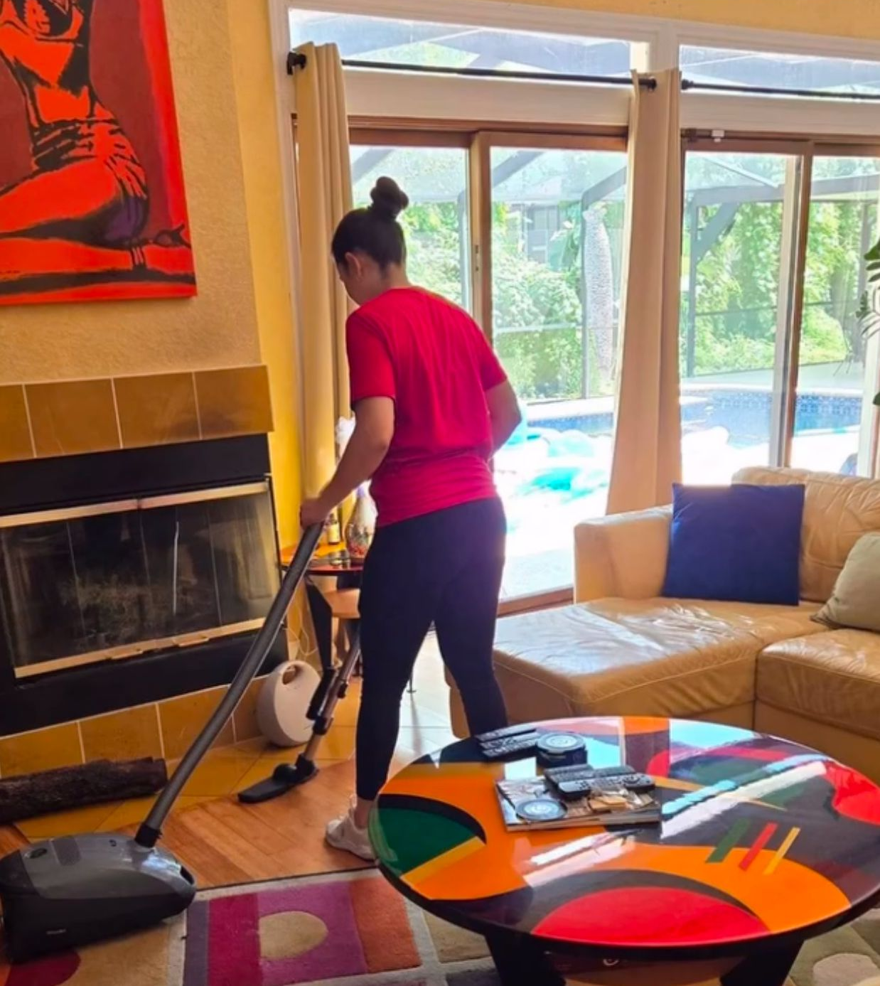 Professional cleaner vacuuming bright living room